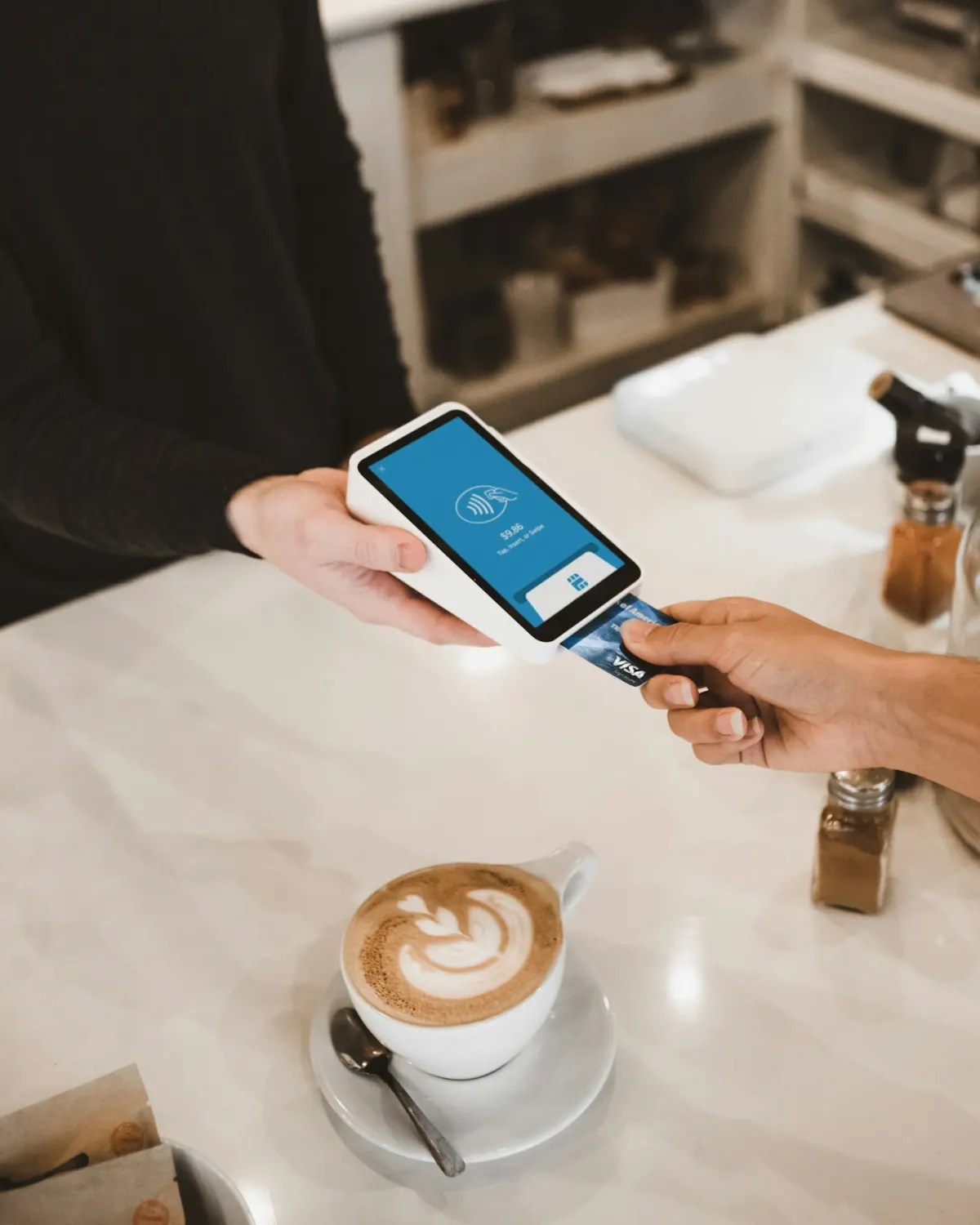 Customer paying by card at a payment terminal