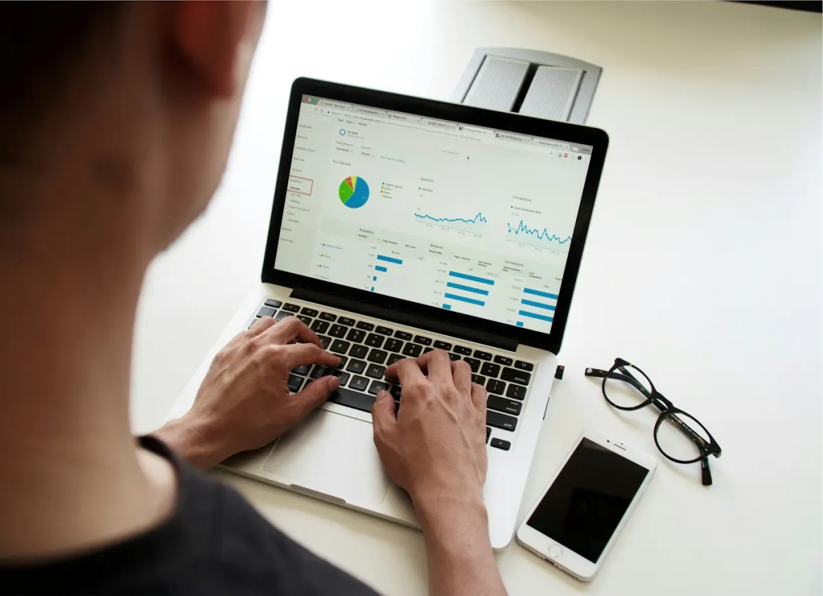 Manager reviewing sales charts on a laptop